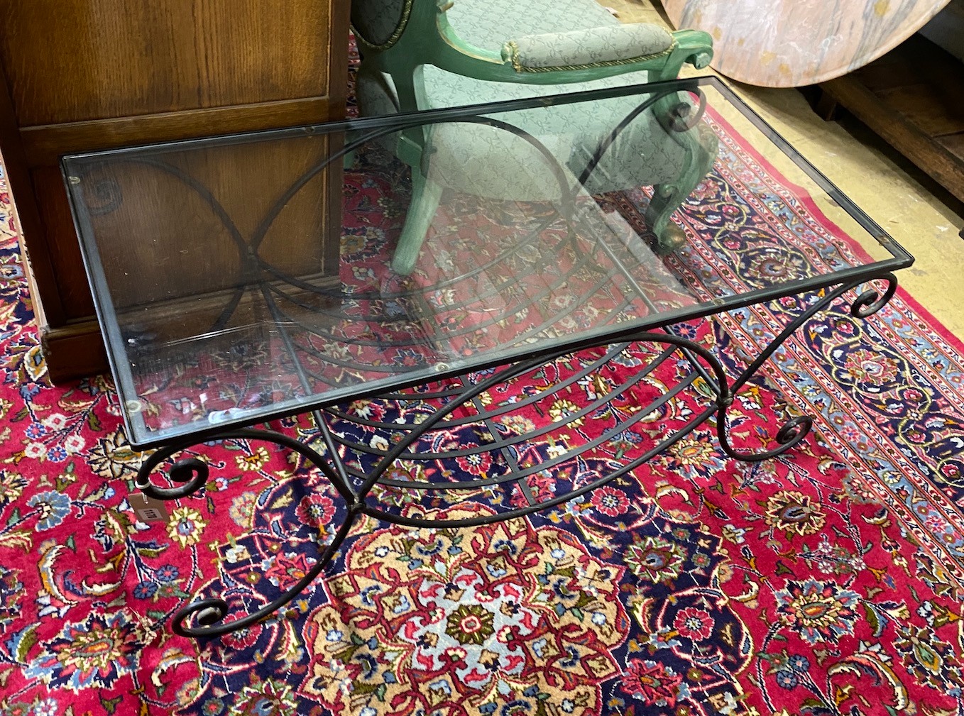 A contemporary metal and glass top rectangular wrought iron coffee table, width 110cm, depth 53cm, height 44cm